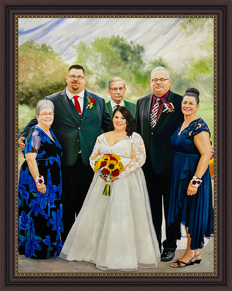 Framed family portrait of a wedding party with the bride at the center